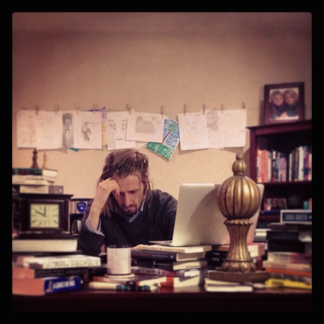 Copyblogger chief copywriter Demian Farnworth sits at his desk straining to write a good syllable